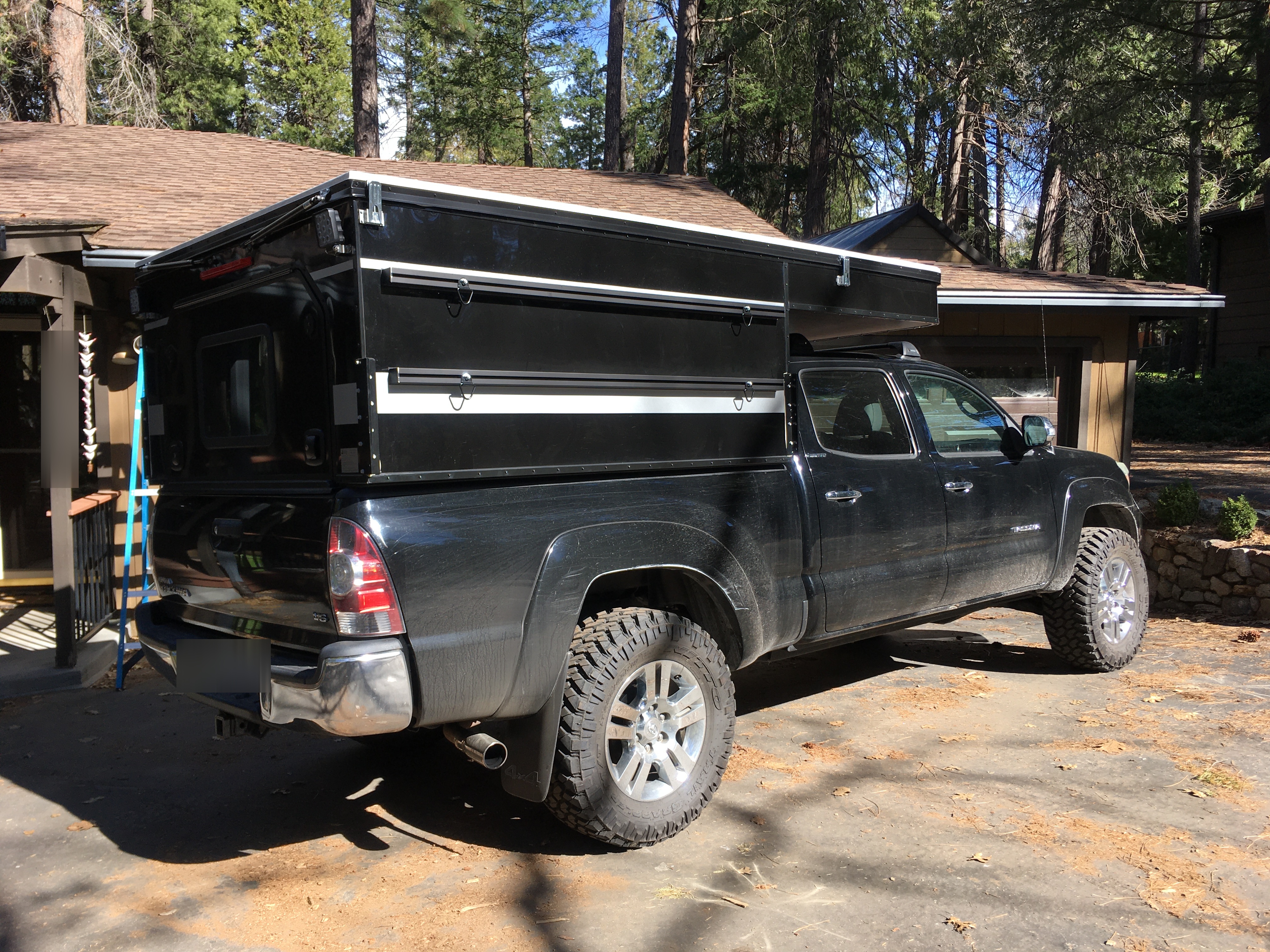 Side view of the Toyota Tacoma and Project M camper setup showing the pop-up design and heavy duty Nitto tires