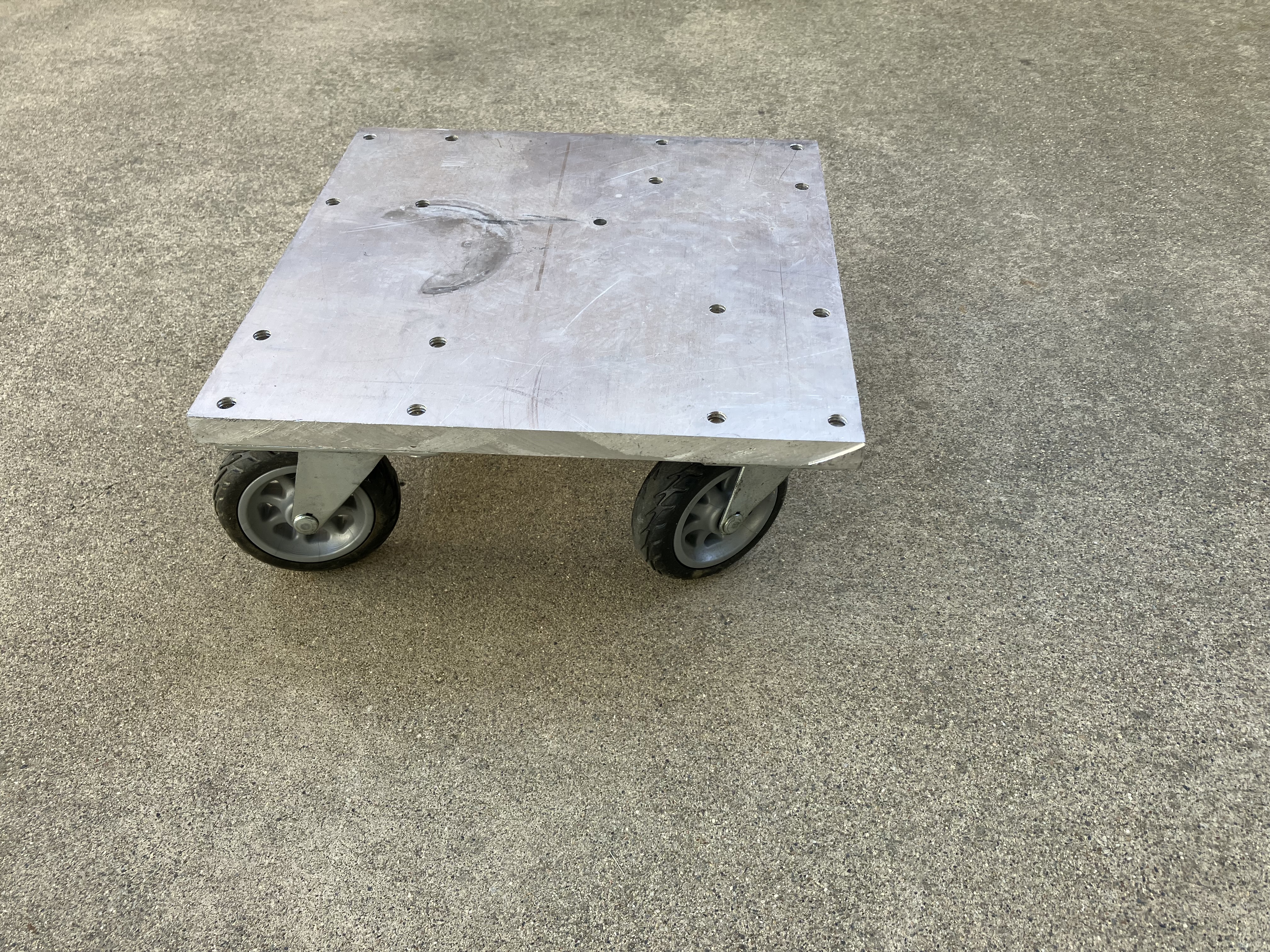 Top view of a custom corner skate showing the riveted aluminum plate that the camper jack rests on while skating the camper into alignment